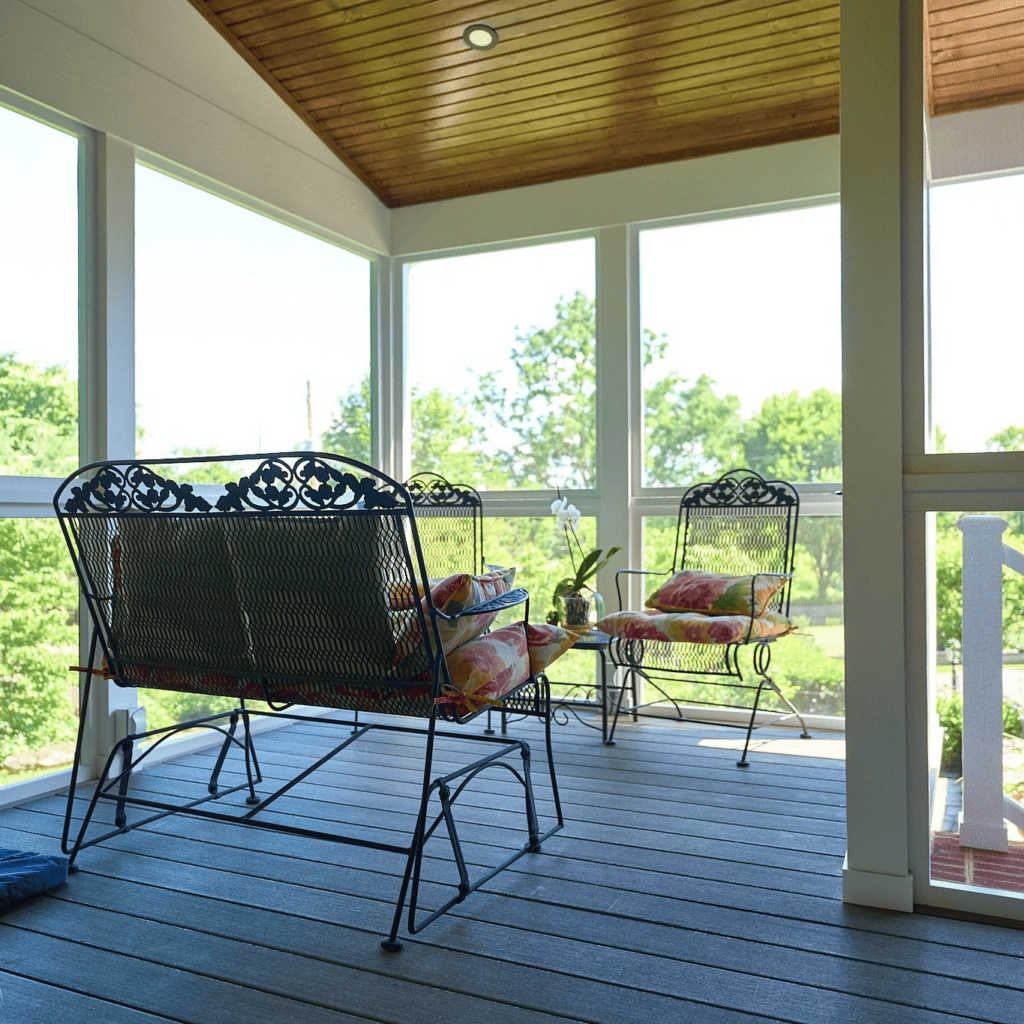 Covered and screened outdoor living space with composite decking and wood ceiling